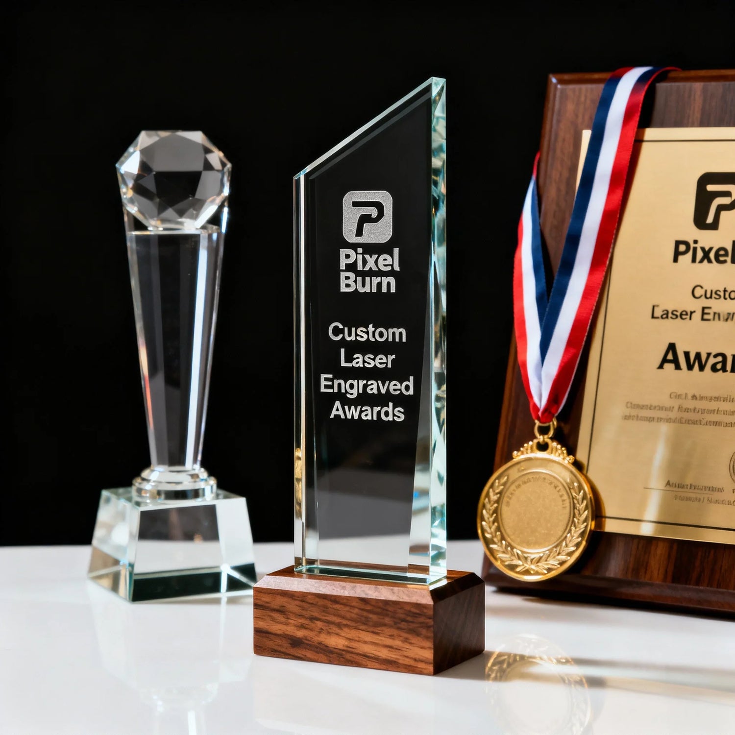 Custom laser engraved glass awards, gold medal, and plaque on display