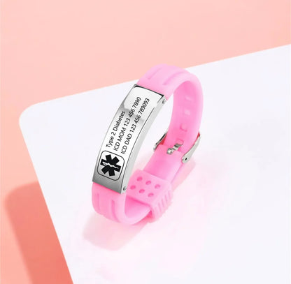 Pink medical alert bracelet with engraved emergency information on a light pink background