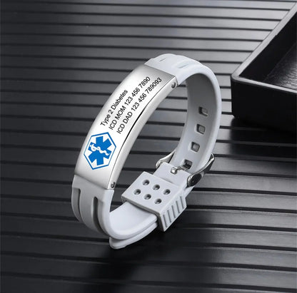 White medical alert ID bracelet for diabetes with engraved emergency contact information on black surface.
