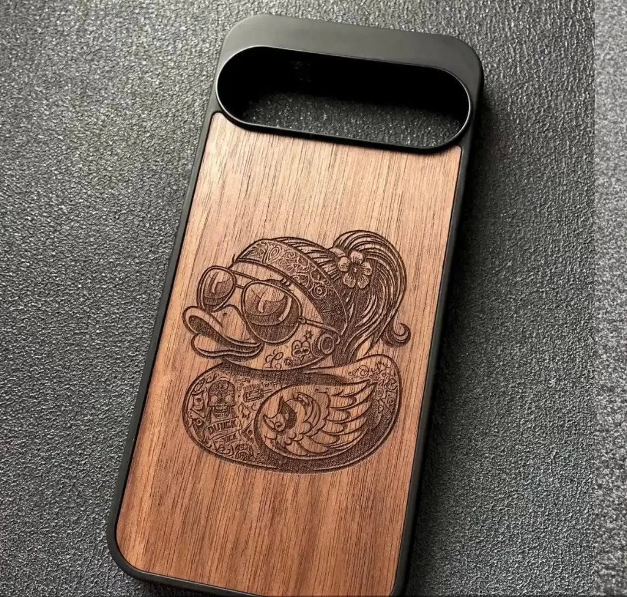 Wood phone case with engraved tattoo duck, sunglasses, bandana design on textured surface