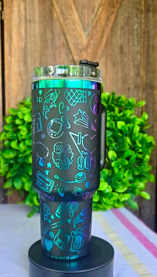 Black tumbler with colorful 90s graphics, outdoor background, wooden wall, and green plant