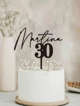 White birthday cake with 'Martina 30' topper and baby's breath flowers, minimalist decor
