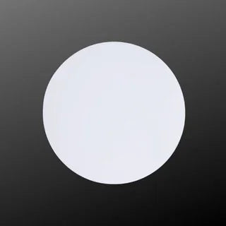 White circular patch on black background, round adhesive pad product photo