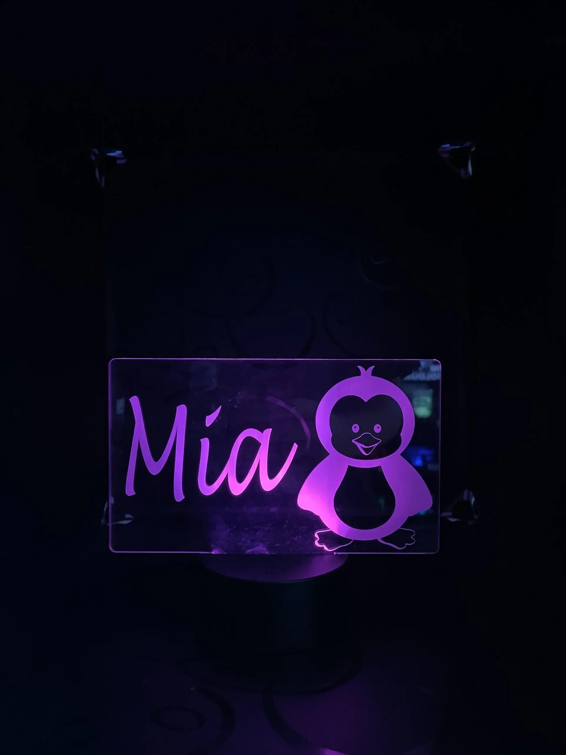 Custom LED acrylic name sign with purple light, 'Mia' and cartoon penguin design
