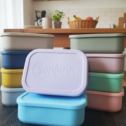 Stack of colorful food containers with 'Contigo' branding against a floral wallpaper background.