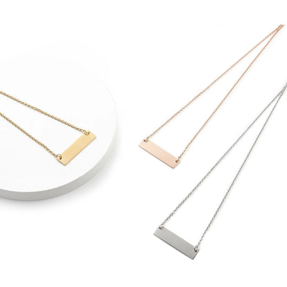 Three necklaces with horizontal bar pendants in gold, rose gold, and silver on a white background.