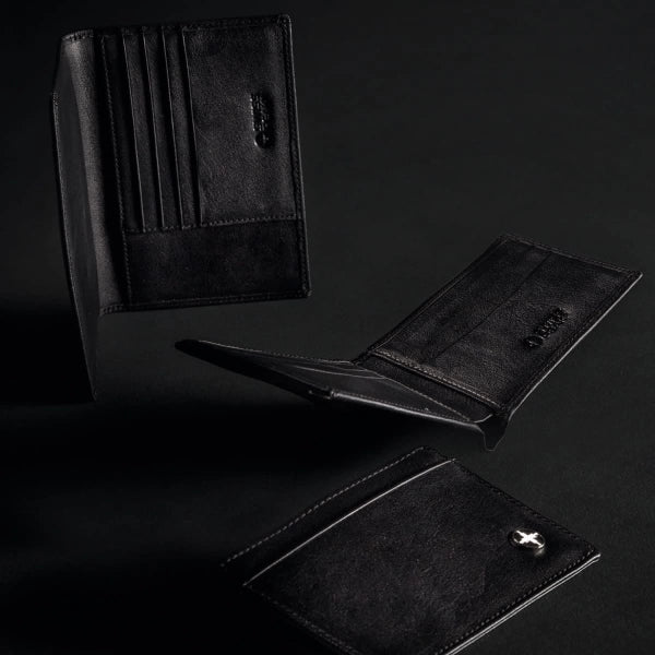 Black leather wallets on a dark background