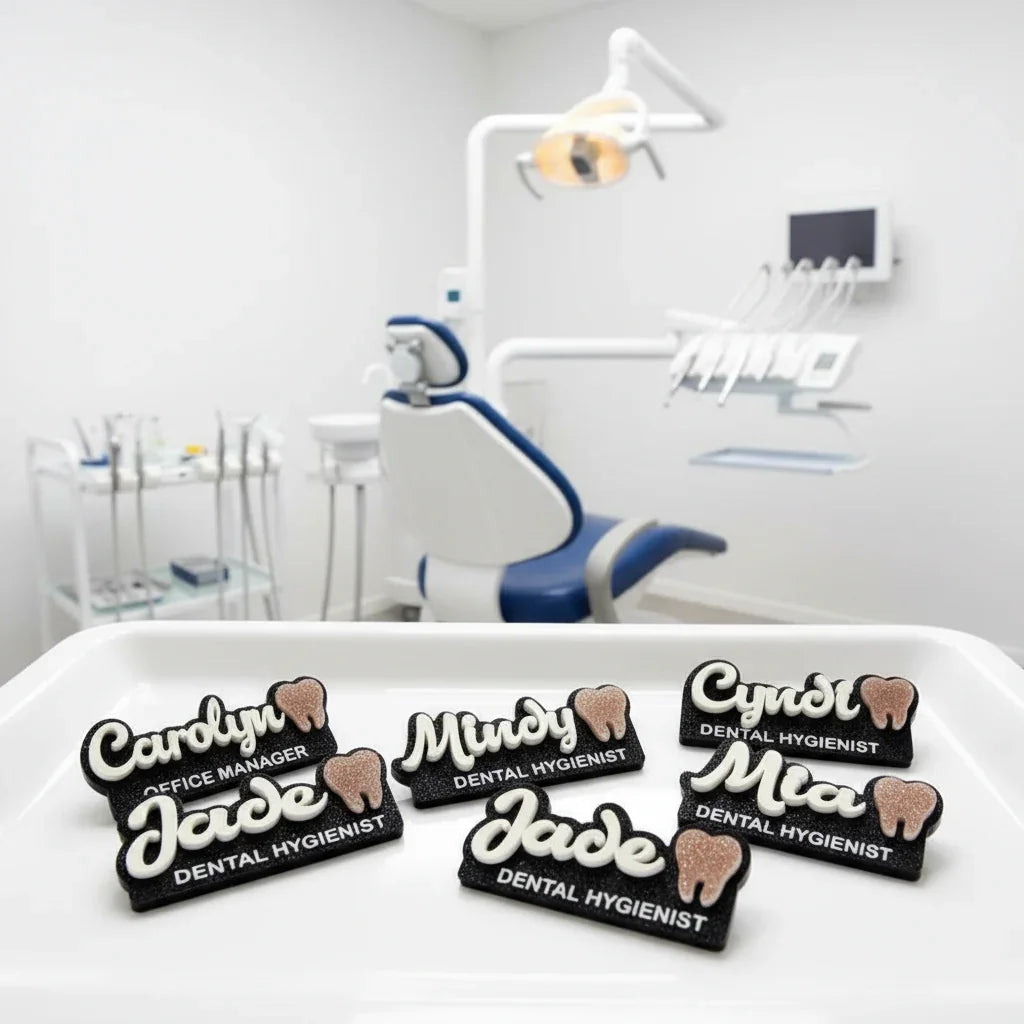 Dental hygienist and office manager name badges on a tray in a modern dental office setting.