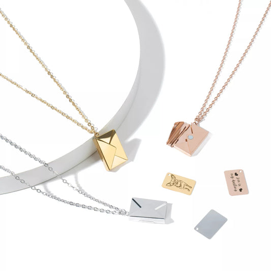 Three necklaces with geometric pendants on a white background